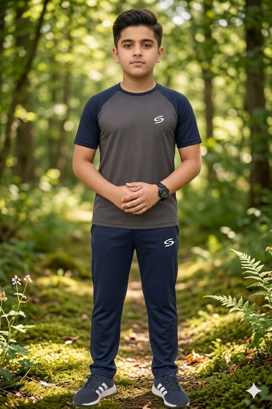 Superwear kid's gray and navy blue dry-fit tracksuit, comfortable athletic clothing for children, shown in a casual pose.