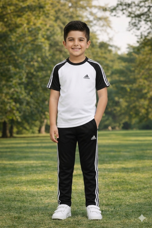 Kid's dry-fit tracksuit by Superwear in white and black, featuring a comfortable athletic design with a zip-up top and matching pants.