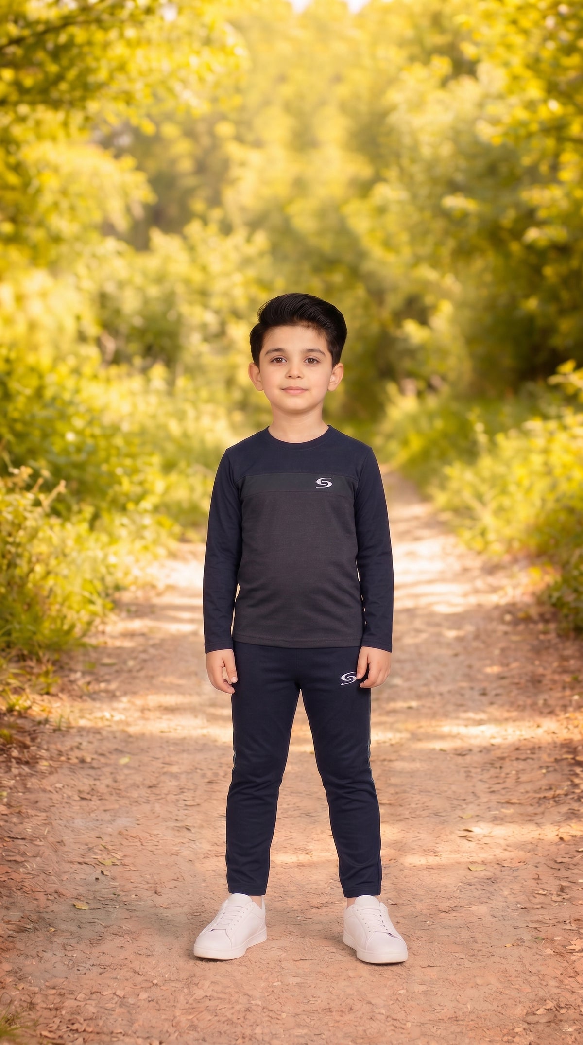 Kid's gray and navy dry-fit tracksuit by Superwear, featuring a long sleeve top and comfortable athletic design.